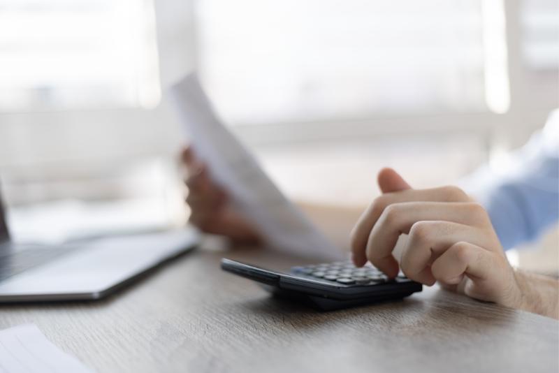 Person working with calculator in hand