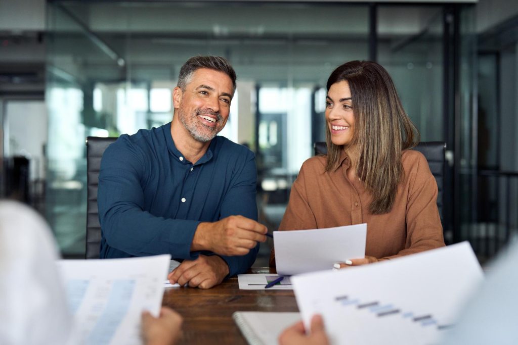 Couple discussing while holding paper